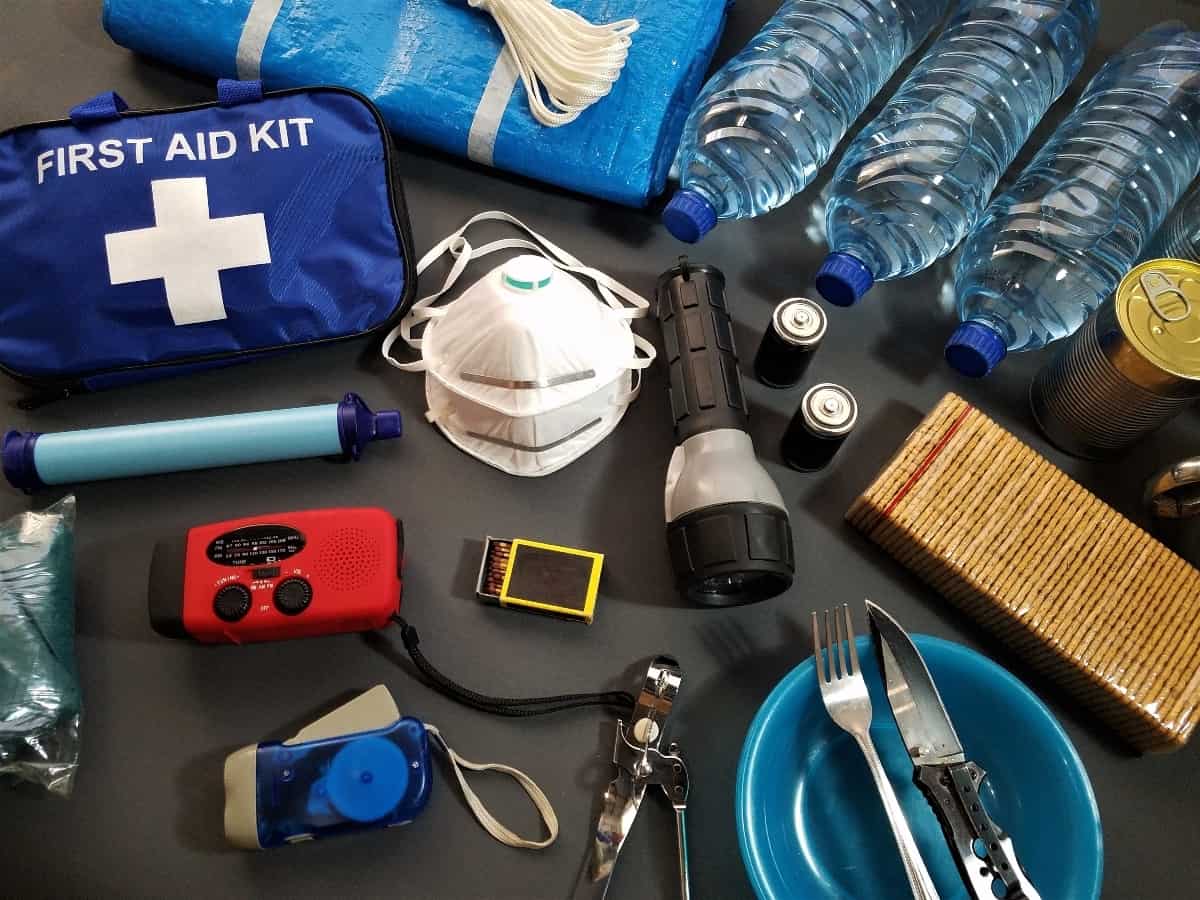 An emergency kit with miscellaneous items scattered across a surface.