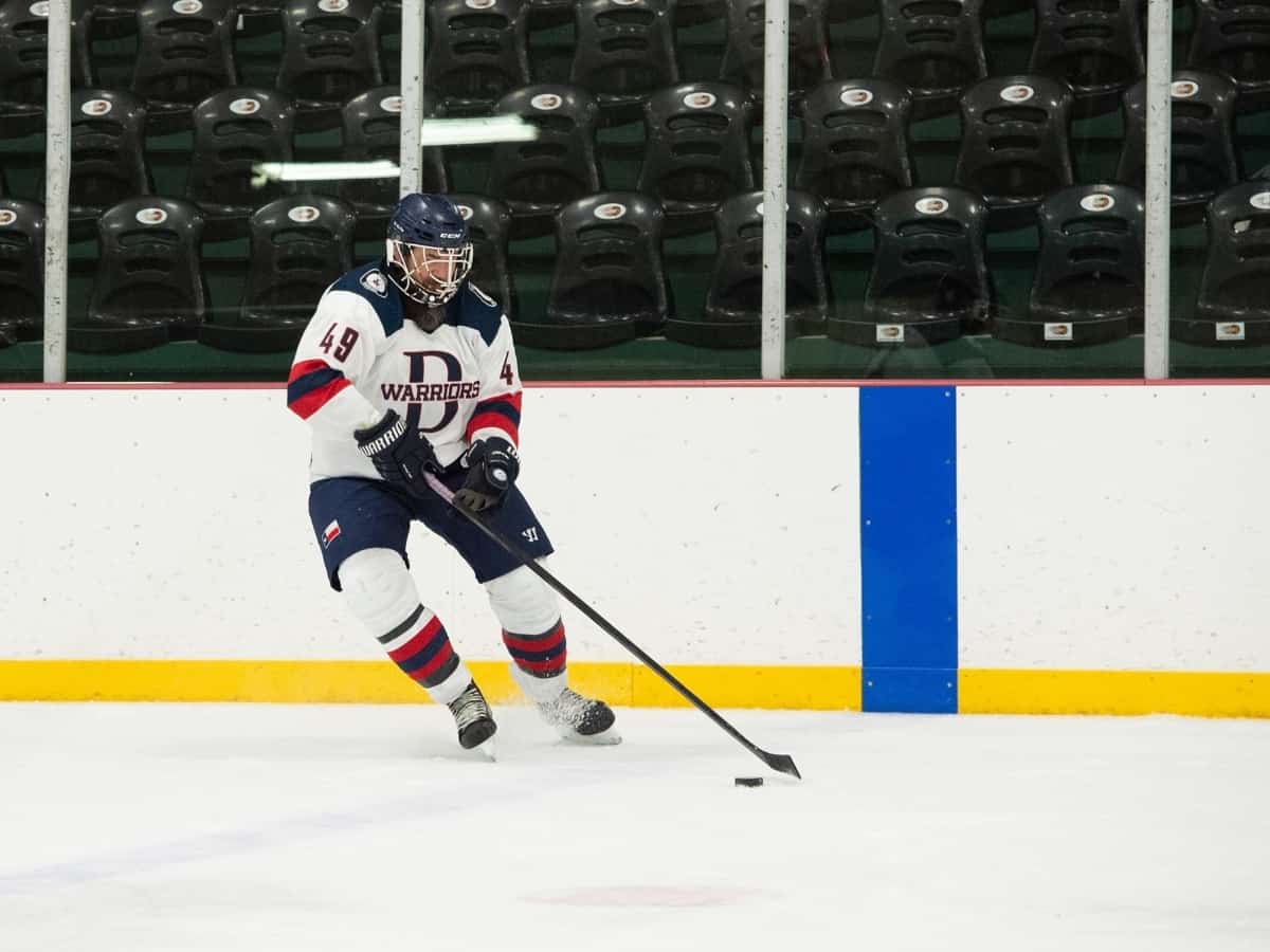 player moving the puck up the ice for the dallas warriors hockey team, a dallas small organization focused on enriching veteran lives