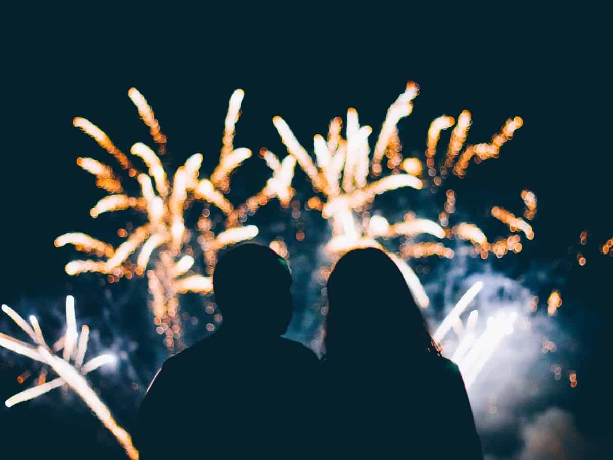 two people looking at fireworks