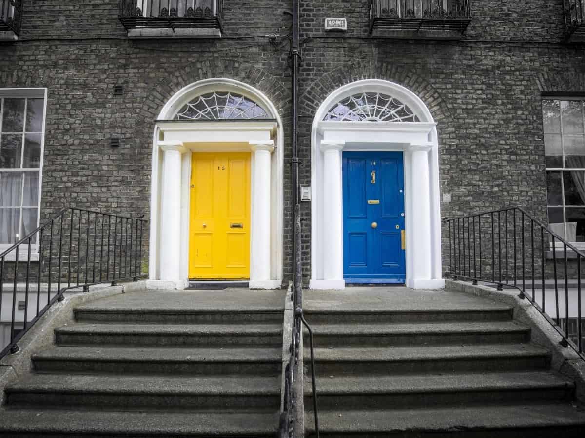 two doors, one blue and one yellow that lead to homes