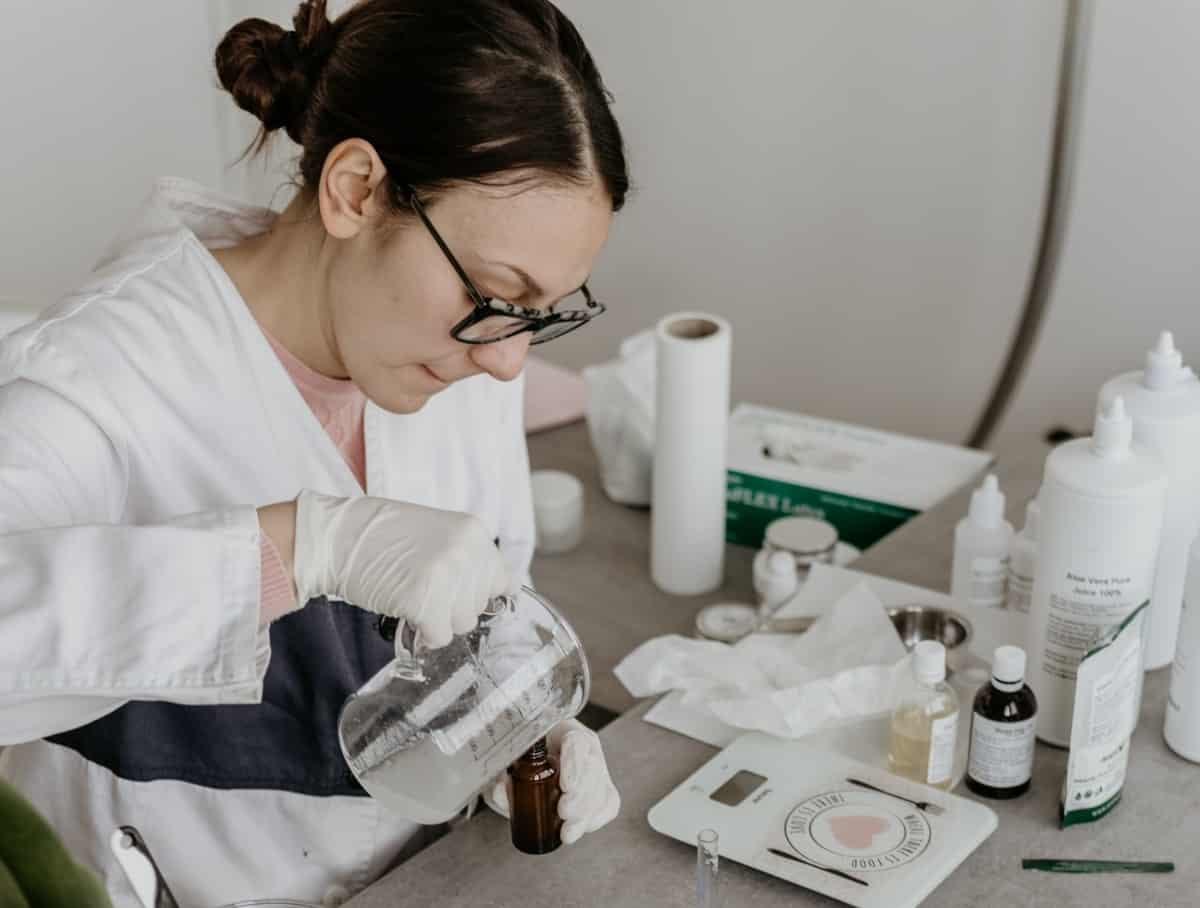 a scientist taking a sample of water and testing it for contaminants