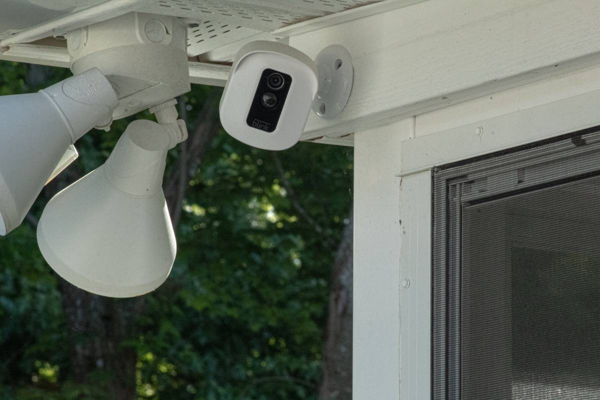 A security camera is installed on the outside of a home.