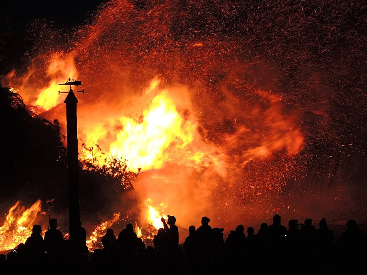 wildfire taking over a town, engulfed in flames