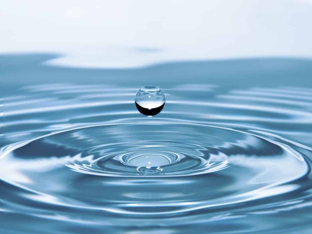 water droplet into a pool of water, showing clean water that can be used through a water softener and filtration system