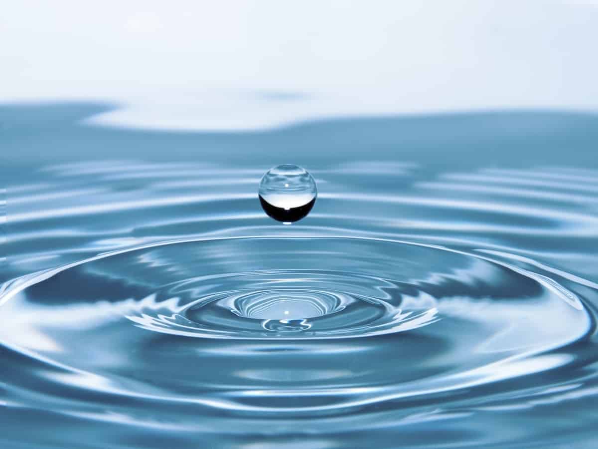 water droplet into a pool of water, showing clean water that can be used through a water softener and filtration system