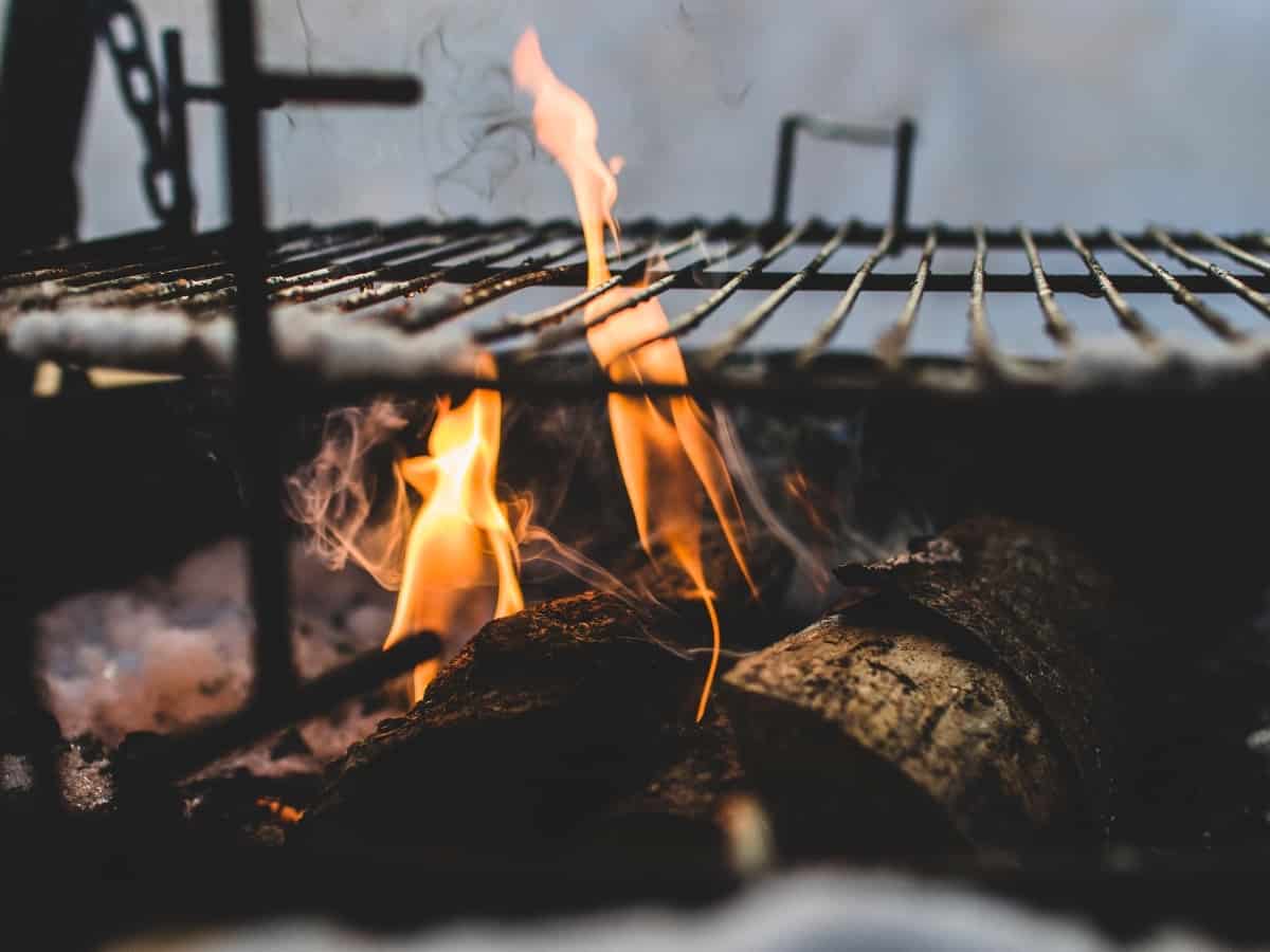 a close up of a fire with a grill above it