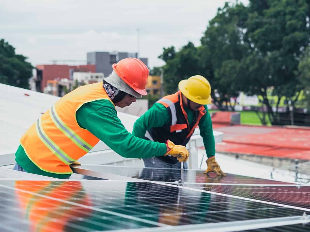 two men working on solar panel installation to make sure it's well maintained with a long lifespan