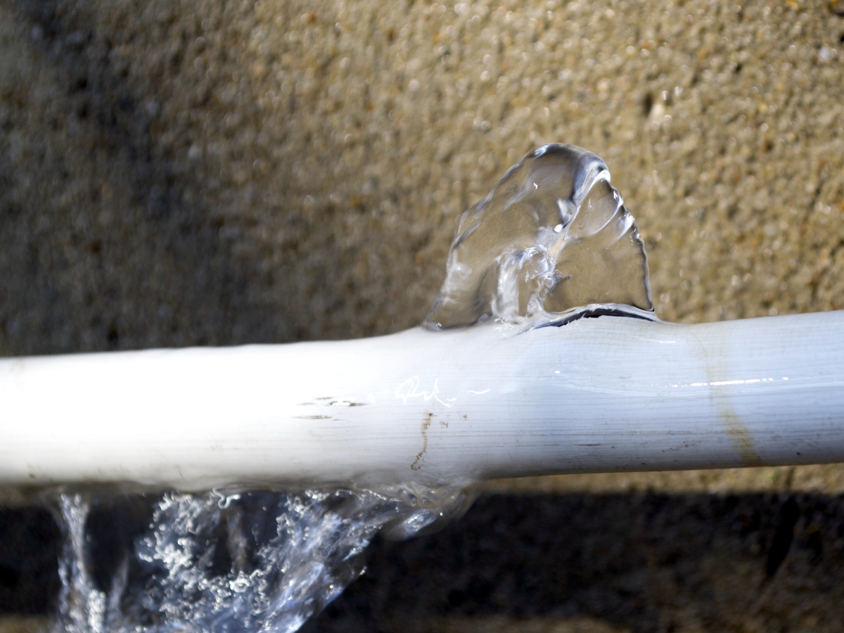 a crack in a pipe that is frozen and bursting