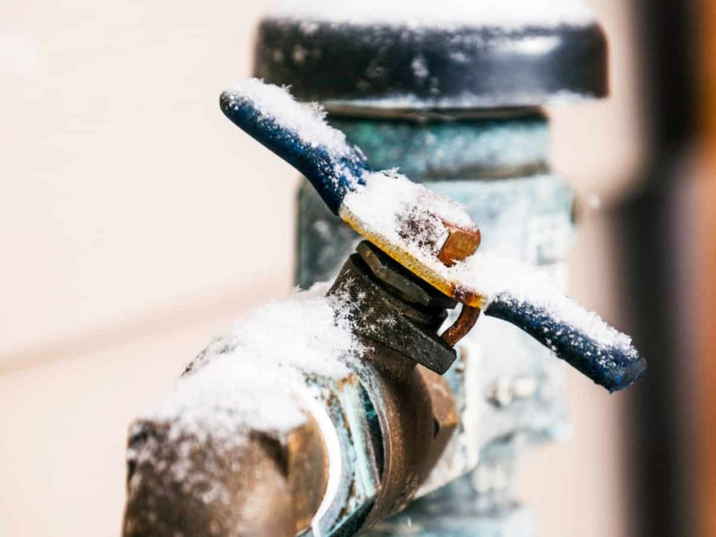 close up of a frozen and snowy pipe