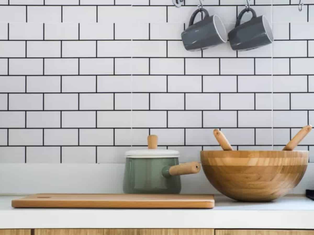 mugs on the backsplash with bowls and rolling pin in the kitchen