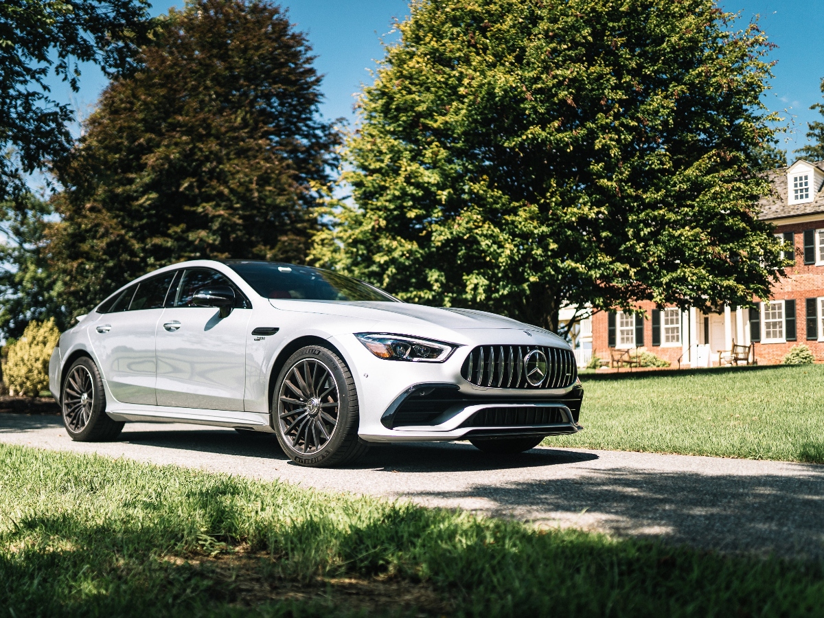 a car in front of a two story brick home