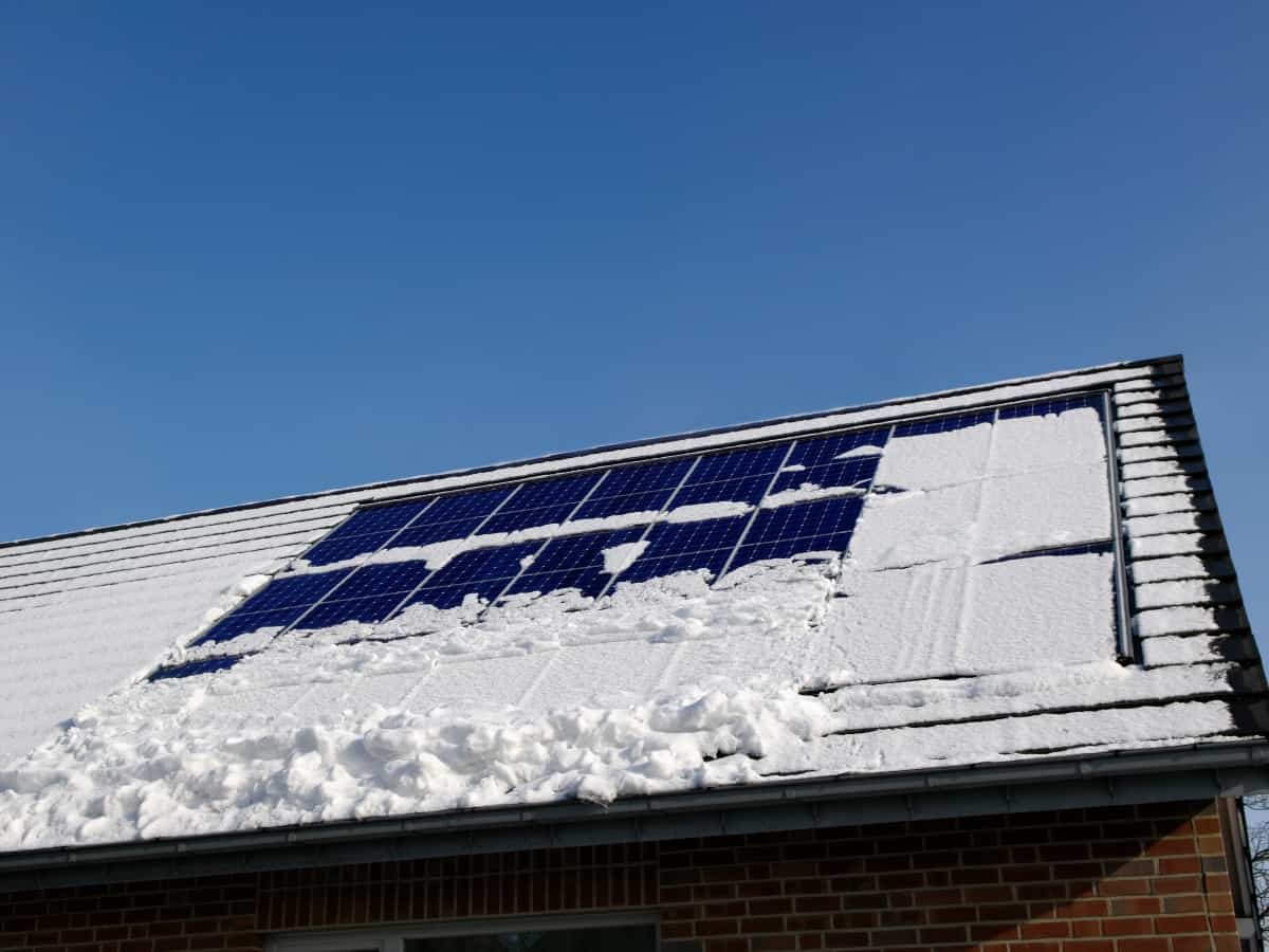 solar panels on a roof with snow during winter