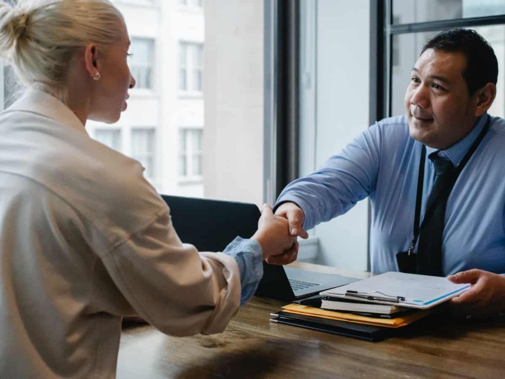 two people shaking hands to