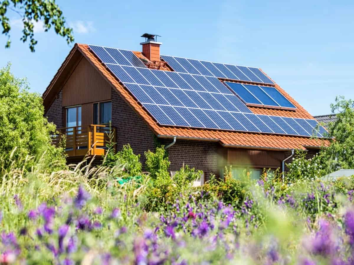 a two story house with solar panels on the roof for a home with solar energy