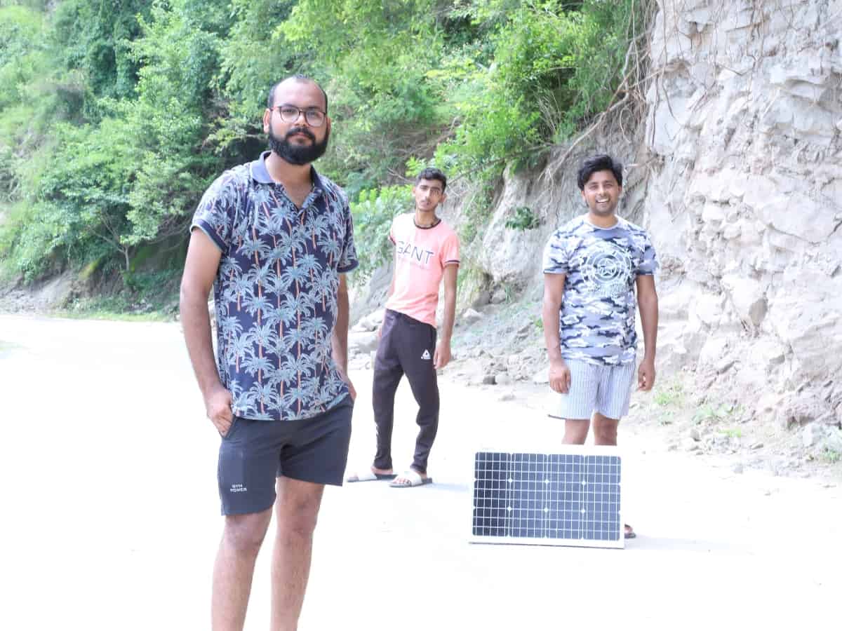 family standing in front of a small solar panel