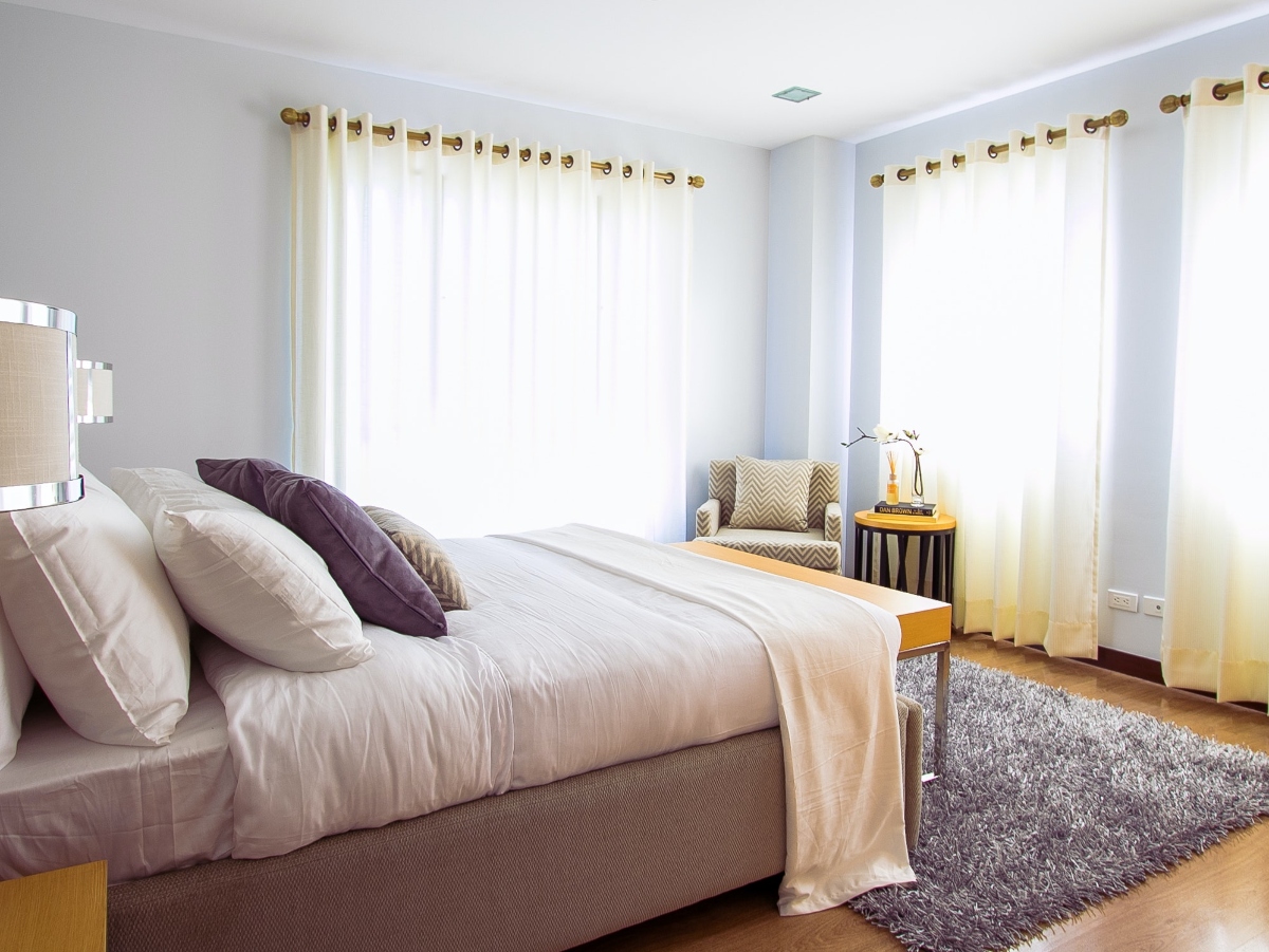 an image of a bedroom with large windows