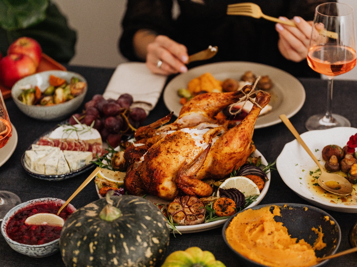 an overview shot of thanksgiving foods including turkey and pumpkins