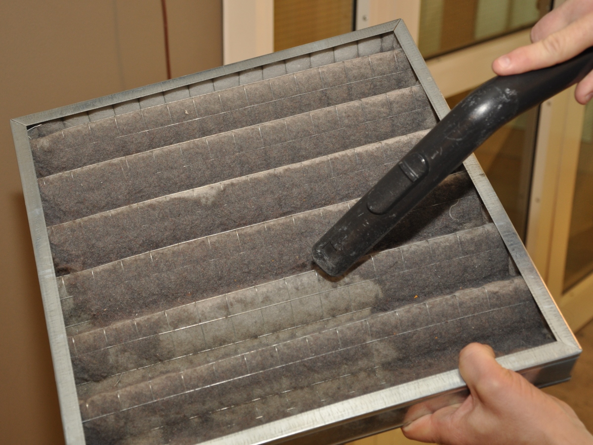 an up close view of someone vacuuming an air filter