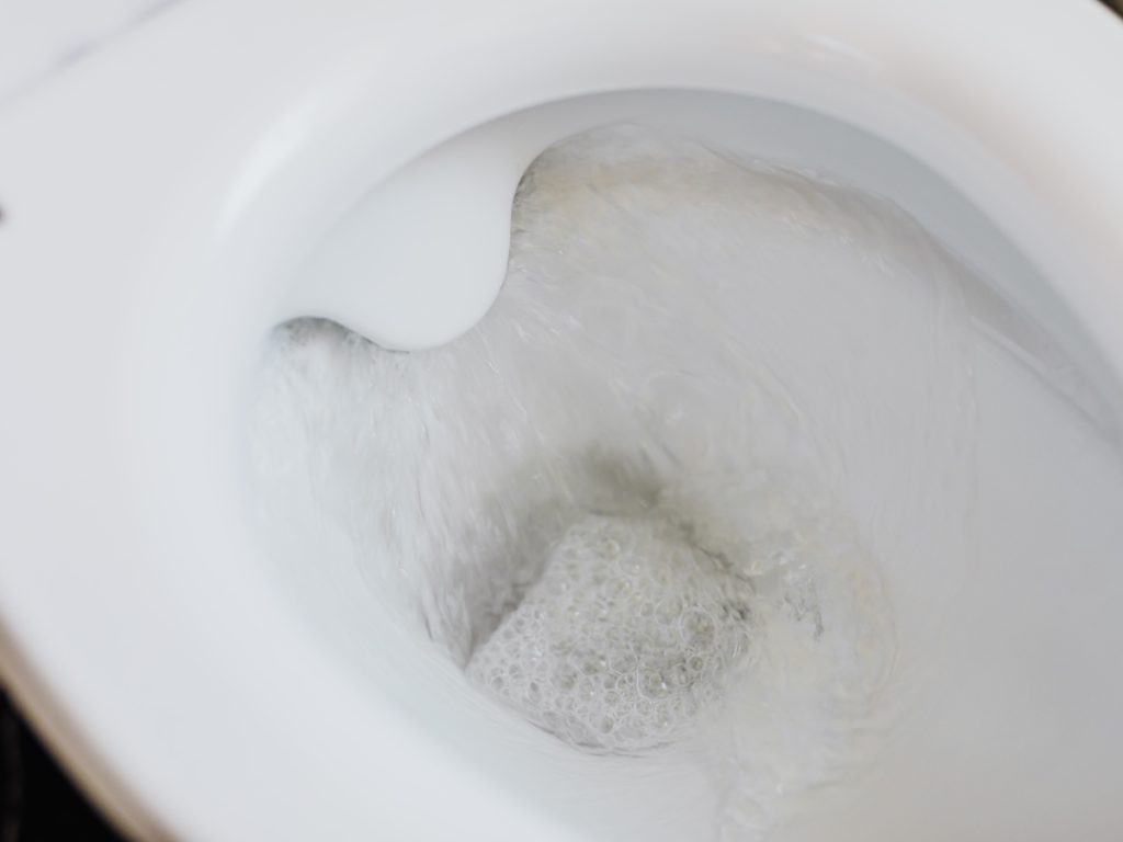 a close up of a toilet running and flushing water out