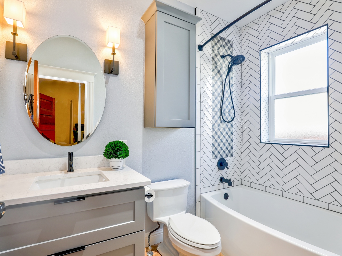 a bathroom view with a vanity sink, toilet, and bath shower combination