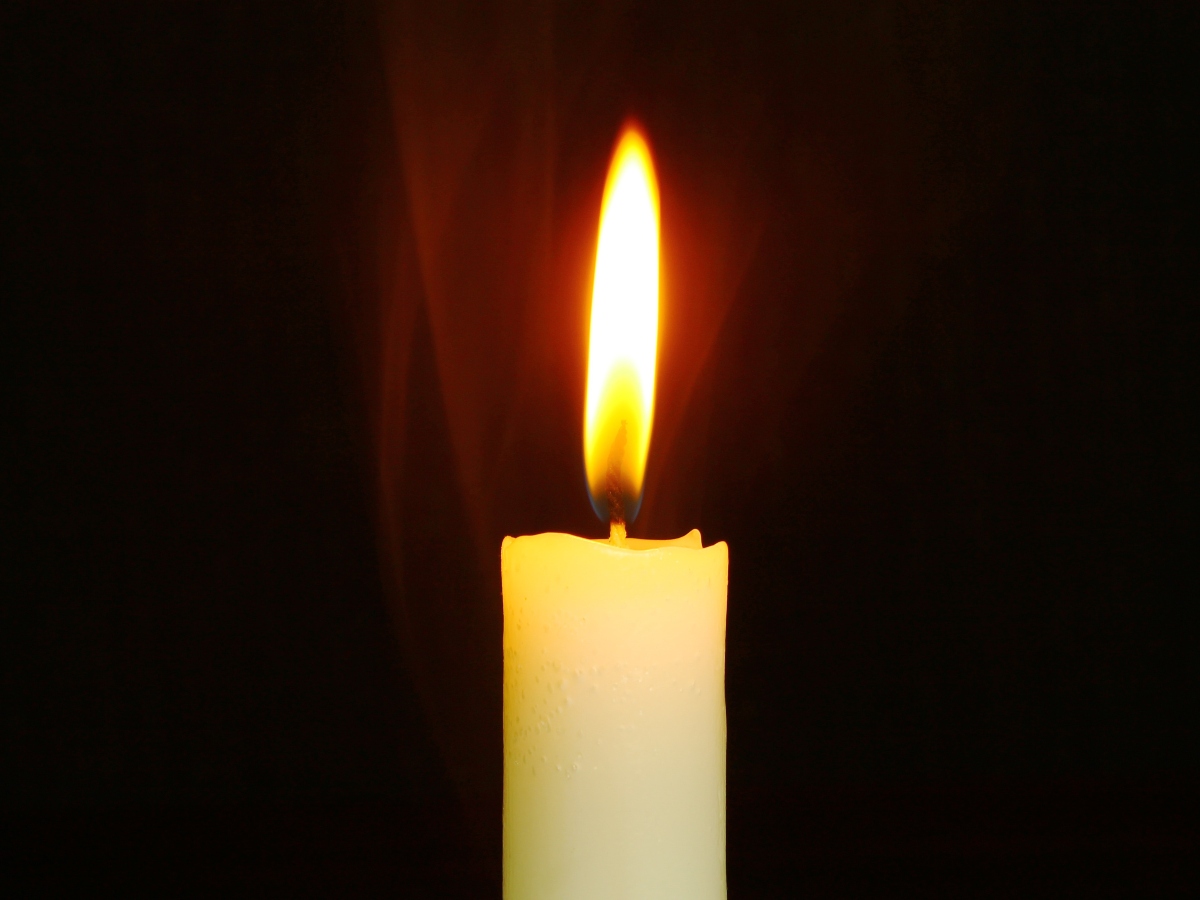 a single flame from a candle used during a power outage