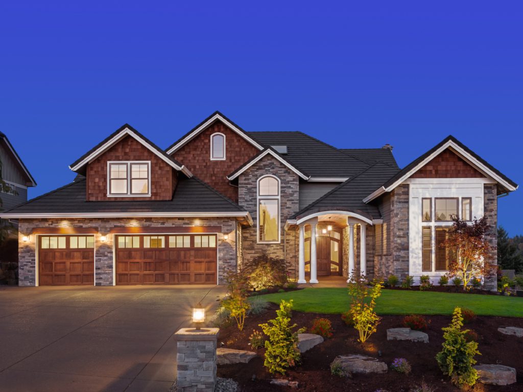 a street view of a home lit up with different outdoor lighting options