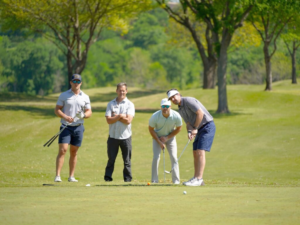 A group of four golfers at the Denton Country Club for the ONIT Home and The Honor Foundation Annual Golf Tournament on April 3, 2023