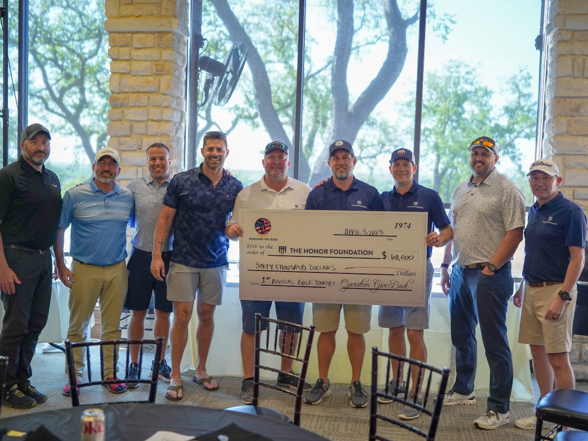 A group from ONIT Home and The Honor Foundation presenting the check with the donation amount following the 2023 ONIT Home x The Honor Foundation Golf Tournament