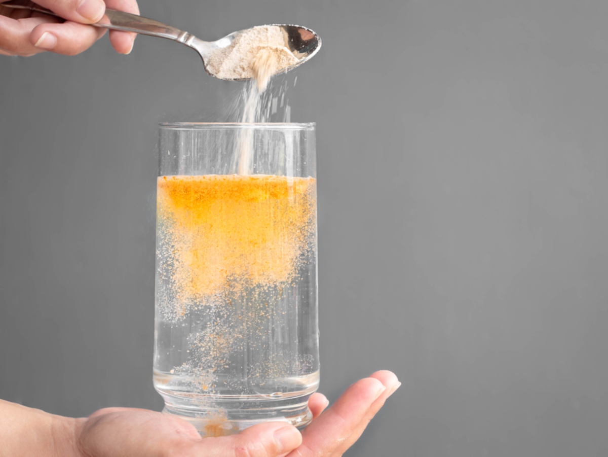 hydration and electrolyte powder pouring into a glass of water for increased hydration
