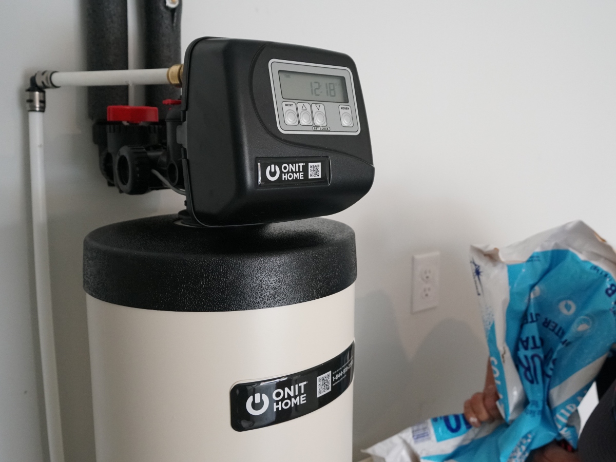 an upclose view of the ONIT Home water filtration system with a blue diamond bag of salt in the right hand corner
