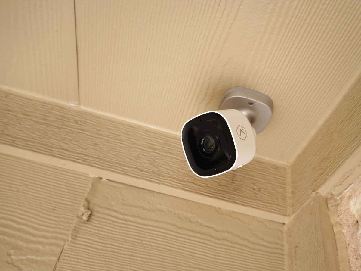 a security camera on the roof of a patio facing left 