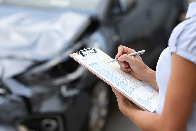 agent inspecting car accident