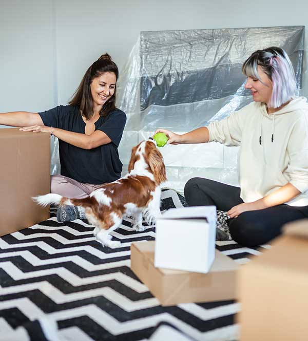 women unpacking with dog
