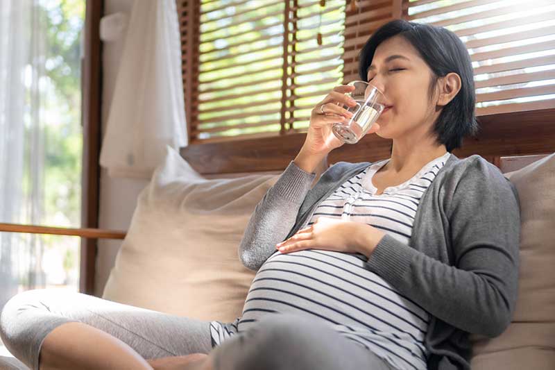 pregnant woman drinking water