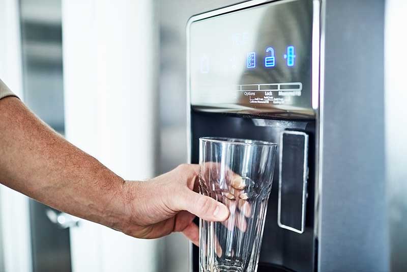 pouring water from fridge filter